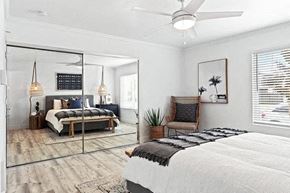 Newport Beach apartment for rent - A bedroom with a bed, chair, and a mirror.