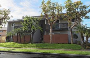 Westminster apartment for rent - A building with a balcony and trees in front of it.