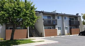 Westminster apartment for rent - A black car is parked in a parking lot in front of a building.