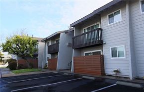 Westminster apartment for rent - A parking lot in front of a two-story apartment building.