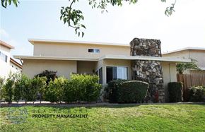 Torrance apartment for rent - A house with a stone chimney and a green lawn in front.