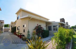 Torrance apartment for rent - A house with a driveway and landscaping in front of it.