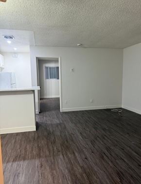 Torrance apartment for rent - A room with a white wall and a wooden floor.