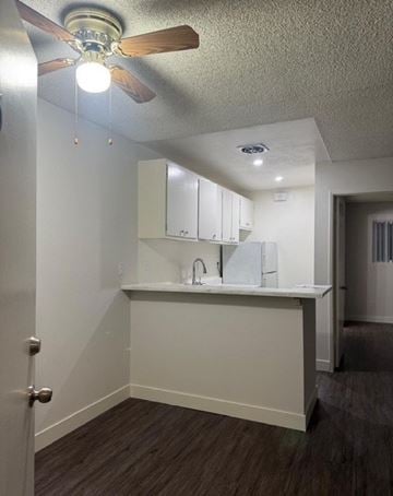 Torrance apartment for rent - A kitchen with white cabinets and a ceiling fan.