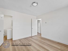 Inglewood apartment for rent - A room with a logo of Beach Front Property Management.