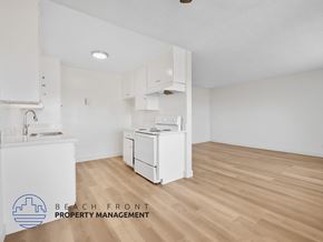 Inglewood apartment for rent - A kitchen with white appliances and wooden floors.