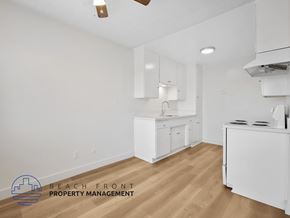 Inglewood apartment for rent - A kitchen with white cabinets and a wooden floor.