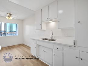 Inglewood apartment for rent - A kitchen with white cabinets and a wooden floor.