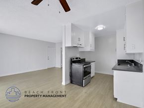 Inglewood apartment for rent - A kitchen with a stove top oven and a sink is shown.