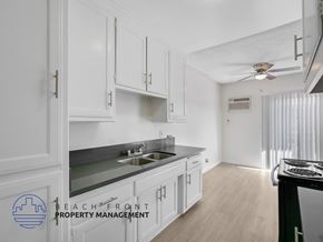 Inglewood apartment for rent - A kitchen with white cabinets and a stove top oven.