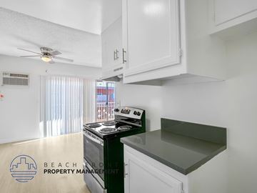 Inglewood apartment for rent - A kitchen with a stove and a fan on the ceiling.
