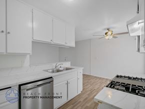 Harbor City apartment for rent - A kitchen with white cabinets and a stove top oven.