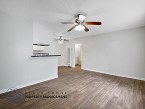 Downey apartment for rent - A spacious room with a ceiling fan and wooden flooring.
