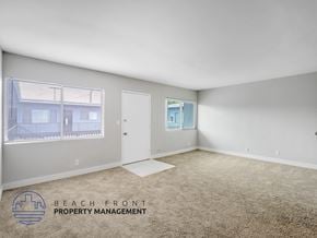 Long Beach apartment for rent - A room with a carpeted floor and a window with blinds.