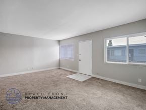 Long Beach apartment for rent - A room with a carpeted floor and a window with blinds.