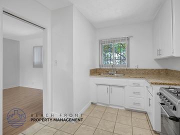 Los Angeles apartment for rent - A kitchen with white cabinets and a granite countertop.