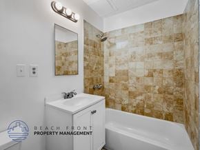 Los Angeles apartment for rent - A bathroom with a tiled shower and a white bathtub.