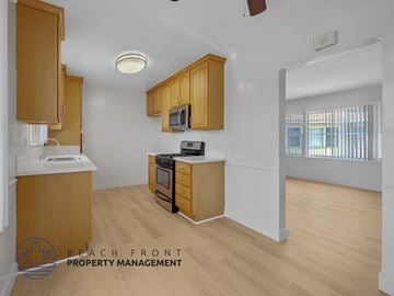 Los Angeles apartment for rent - A kitchen with wooden cabinets and a white countertop.