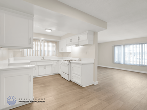 Inglewood apartment for rent - A spacious kitchen with white cabinets and a wooden floor.