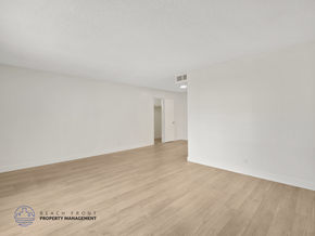 Inglewood apartment for rent - A spacious room with wooden flooring and white walls.