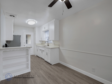 Los Angeles apartment for rent - A kitchen with white cabinets and a ceiling fan.