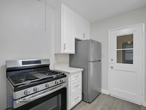 Los Angeles apartment for rent - A kitchen with a stove, refrigerator, and cabinets.
