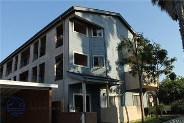 Long Beach apartment for rent - a blue and white building with a tree in front of it
