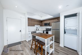 Los Angeles apartment for rent - A kitchen with a wooden table and bar stools.