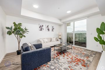 Los Angeles apartment for rent - A living room with a blue couch and a glass coffee table.