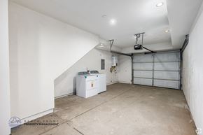 Los Angeles apartment for rent - A spacious garage with a white wall and a white washing machine.