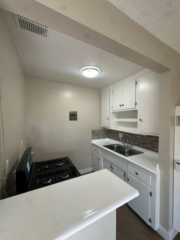Anaheim apartment for rent - A small kitchen with a white counter top and a black stove.