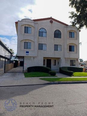 Hawthorne apartment for rent - the front of a building with a sidewalk and a gate