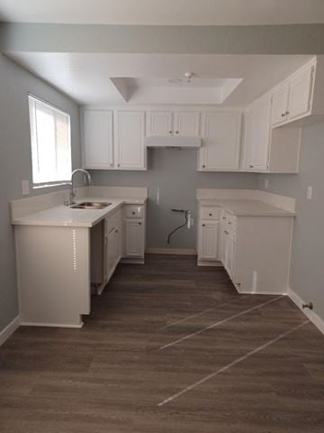 Hawthorne apartment for rent - a kitchen with white cabinets and a sink and a window