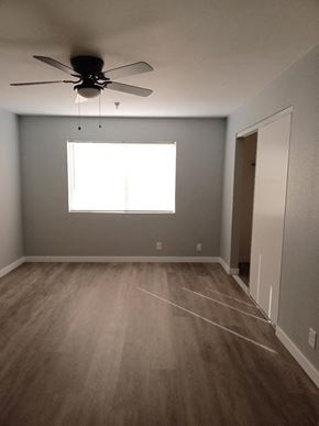 Hawthorne apartment for rent - an empty room with a ceiling fan and a window
