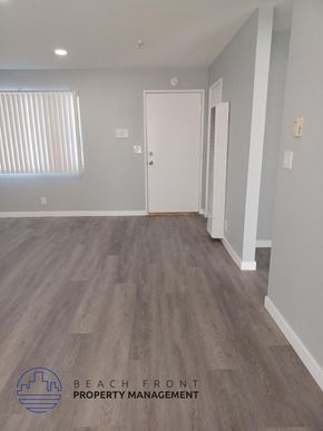 Hawthorne apartment for rent - a renovated living room with wood flooring and a white door