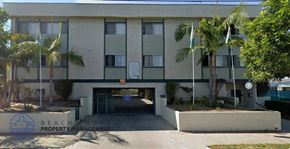 Wilmington apartment for rent - A building with a sign that says Beachfront Property Management.