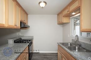 Norwalk apartment for rent - A kitchen with granite countertops and wooden cabinets.
