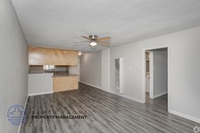 Norwalk apartment for rent - A spacious room with a ceiling fan and wooden flooring.