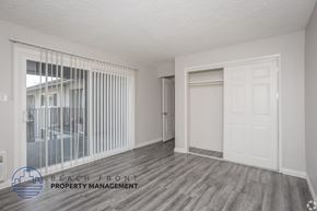 Norwalk apartment for rent - A room with a sliding glass door and a white door.