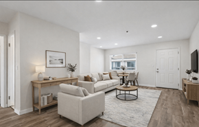 Hawthorne apartment for rent - A living room with a white couch, a coffee table, and a television.