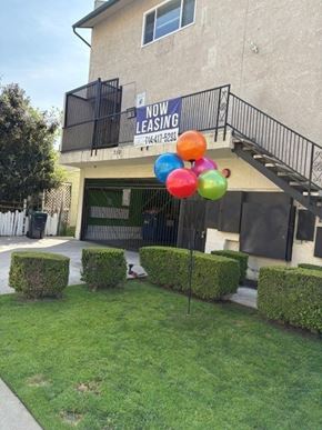 Santa Ana apartment for rent - A building with a balcony and a sign that says "Now Leasing".