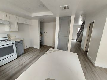 Westminster apartment for rent - A kitchen with a white stove top oven and a white counter top.
