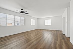 San Pedro apartment for rent - A room with a ceiling fan and wooden flooring.