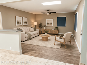Redondo Beach apartment for rent - A living room with a white couch, a wooden coffee table, and a ceiling fan.