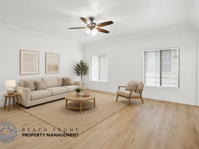 Long Beach apartment for rent - A living room with a couch, chair, and a ceiling fan.
