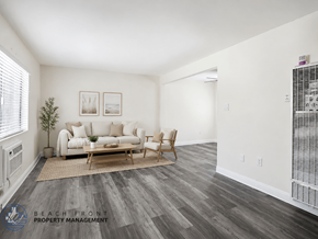Whittier apartment for rent - A living room with a couch, chair, and pictures on the wall.