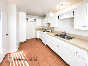 Lynwood apartment for rent - A kitchen with white cabinets and a tiled floor.