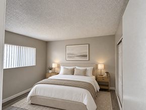 Long Beach apartment for rent - A bedroom with a large bed and a painting above it.