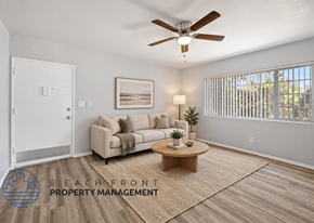Long Beach apartment for rent - A living room with a couch, coffee table, and a ceiling fan.