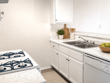 Torrance apartment for rent - A kitchen with a white stove top and white cabinets.